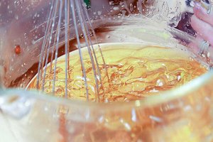Whisk in a glass bowl of melted carrier oils, butters, and wax.